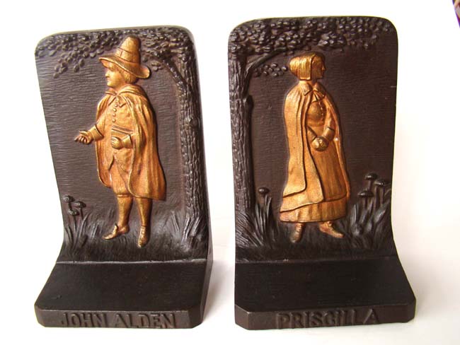A fine pair of Bradley & Hubbard bookends circa 1925 depicting the Puitan father JOHN ALDEN and his wife PRISCILLA